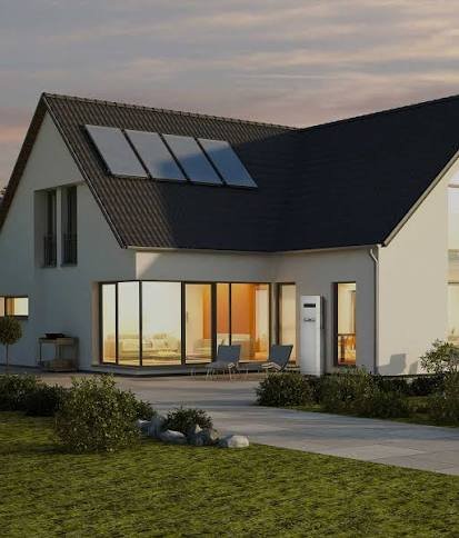 Home at dusk with rooftop solar and a wall-mounted GoodWe hybrid inverter and battery